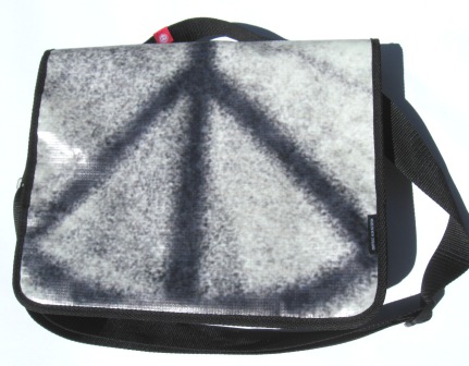 A recycled laptop bag made from Powershop's Electricity vs Power billboard campaign.